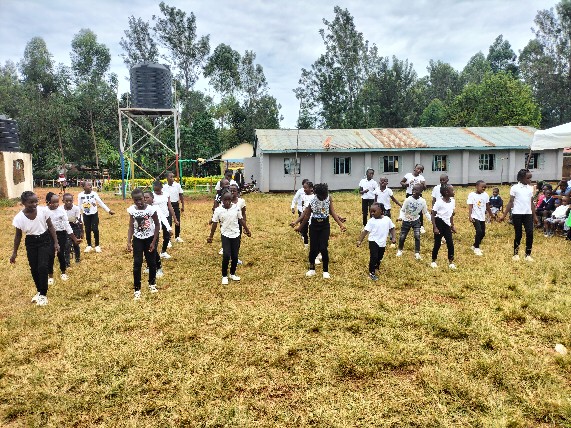 Pupils performing a synchronised dance outdoors