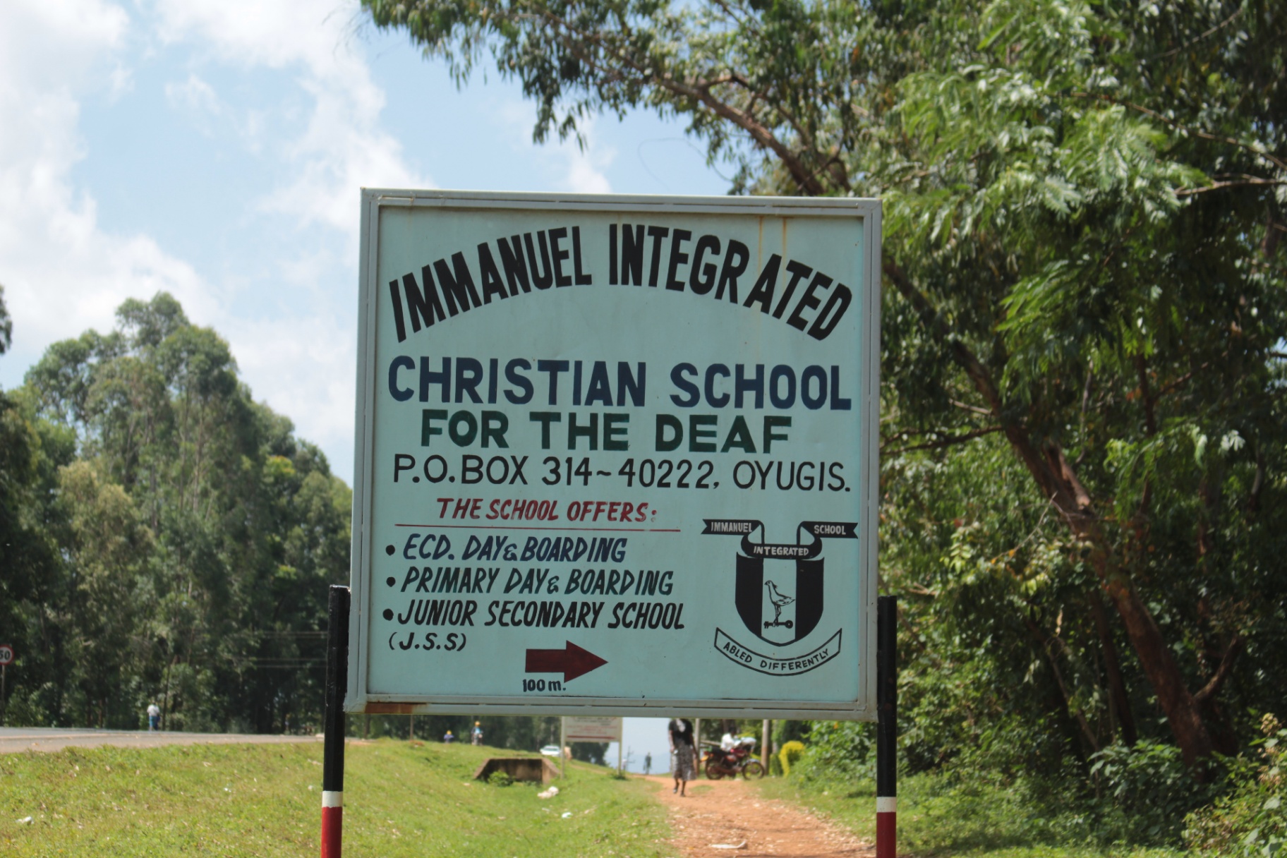 Signpost by the road pointing to Immanuel Integrated Christian School for the Deaf