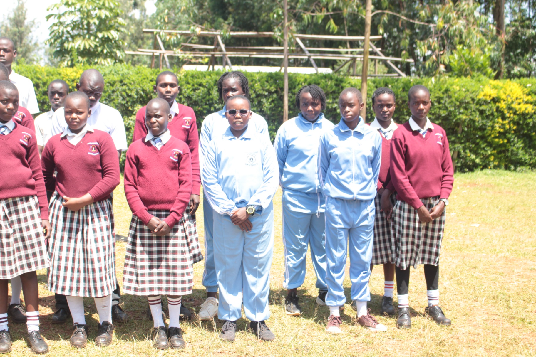 Junior secondary learners standing together in school uniform